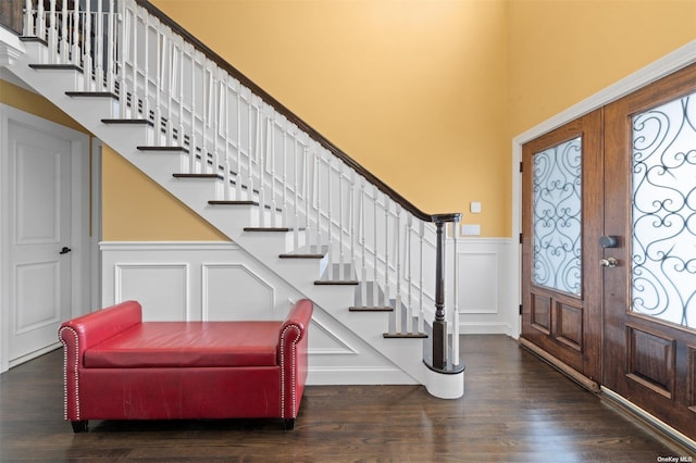 foyer featuring dark wood-type flooring, french doors, and a healthy amount of sunlight