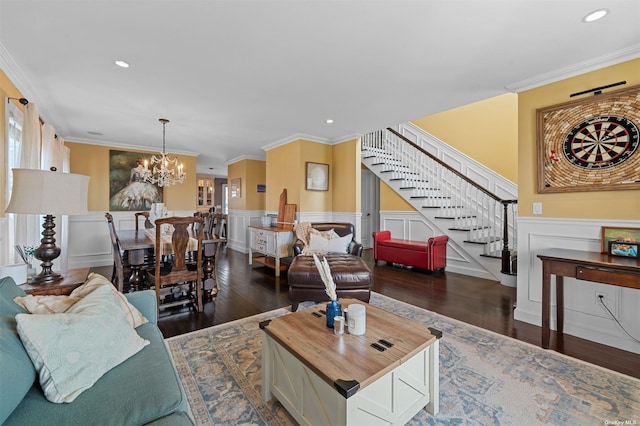 living room featuring a notable chandelier, dark wood-type flooring, and ornamental molding