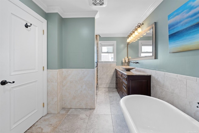 bathroom with crown molding, vanity, a bath, and tile walls