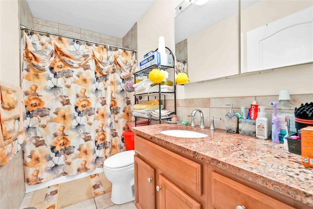 bathroom with tasteful backsplash, tile patterned flooring, vanity, walk in shower, and toilet