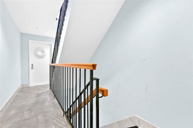 stairway featuring tile patterned flooring