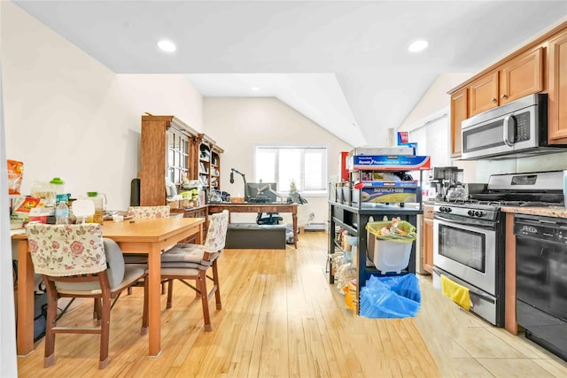 kitchen featuring lofted ceiling, stainless steel appliances, and light hardwood / wood-style flooring