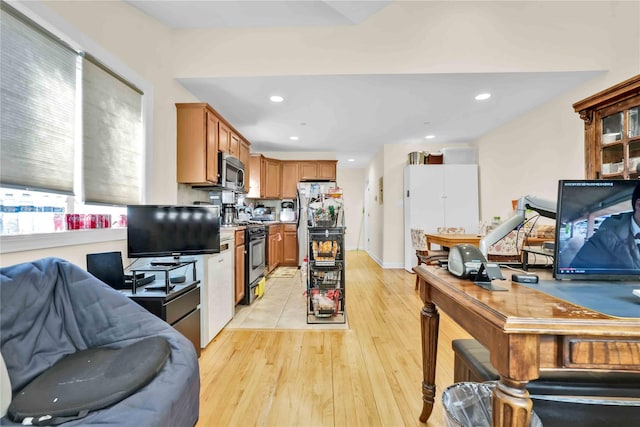 kitchen with stainless steel appliances and light hardwood / wood-style flooring