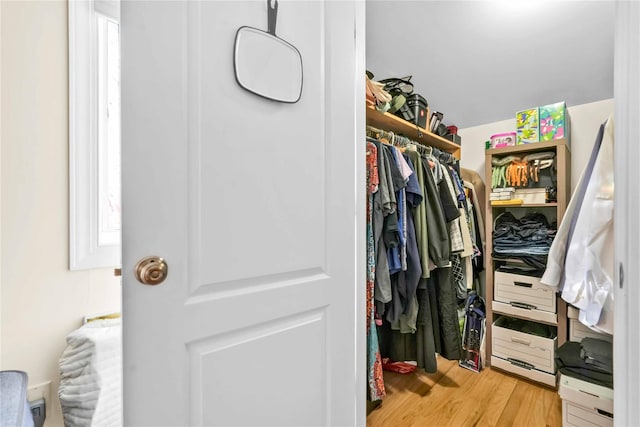 walk in closet featuring light hardwood / wood-style flooring