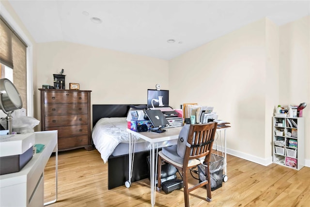 bedroom featuring vaulted ceiling and light hardwood / wood-style flooring