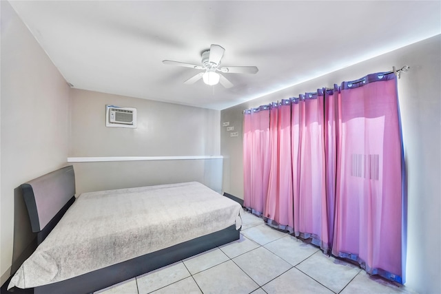 unfurnished bedroom with ceiling fan, light tile patterned floors, and a wall unit AC