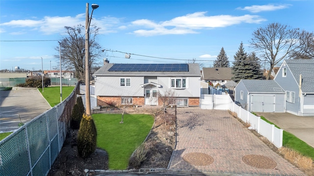 view of front of house with a front lawn and solar panels