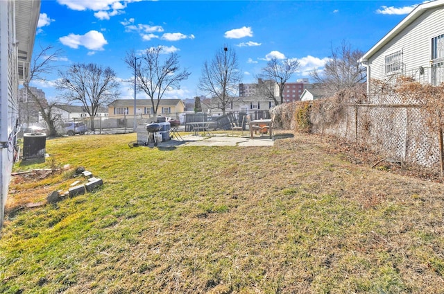 view of yard with central AC unit and a patio area