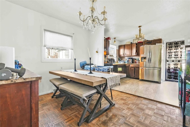 dining room with a notable chandelier, a textured ceiling, and light parquet floors