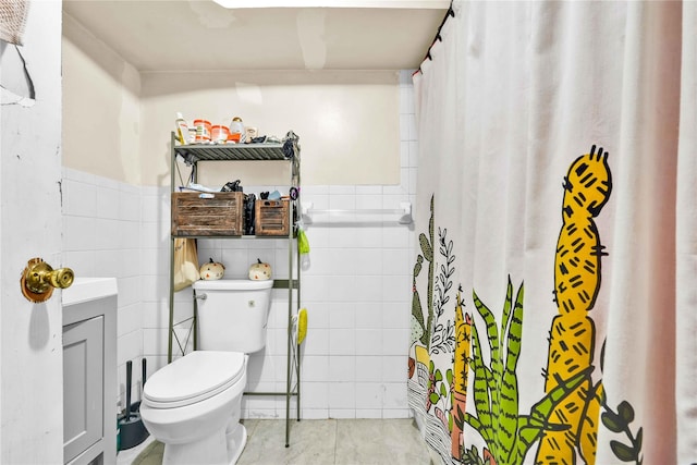 bathroom featuring walk in shower, toilet, and tile walls