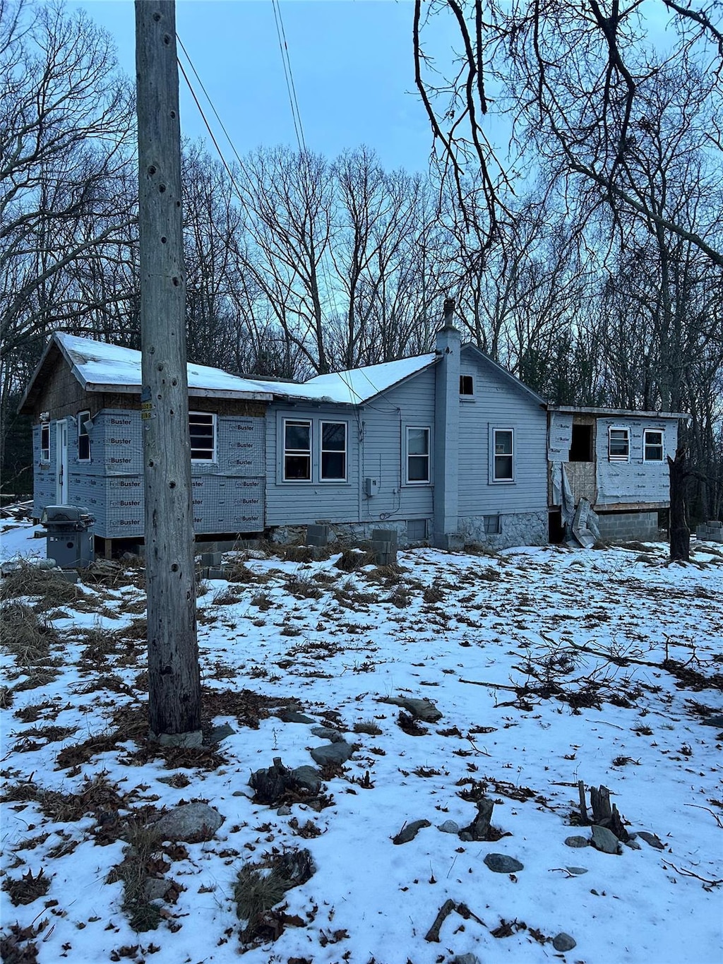 view of snow covered back of property