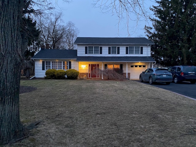 view of front of home featuring a garage and a front yard