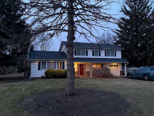 view of front of house with a garage and a front yard