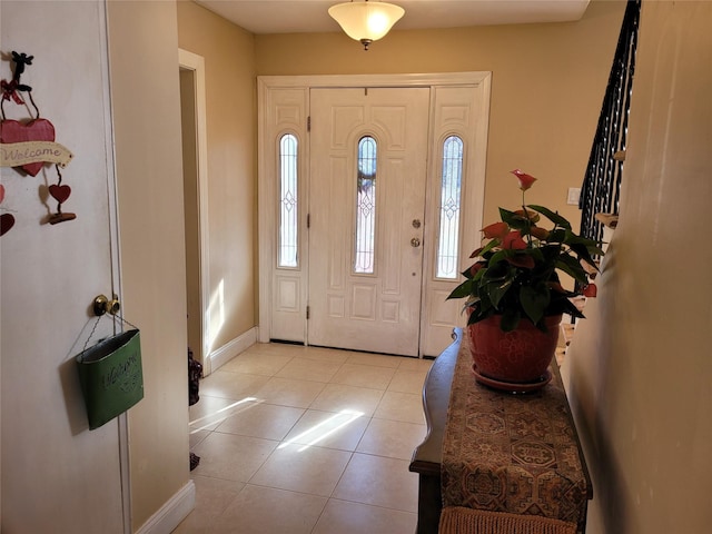 entryway with light tile patterned flooring