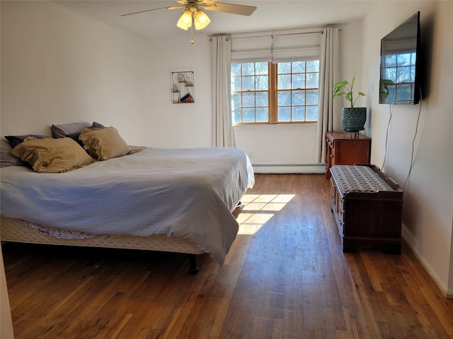 bedroom featuring ceiling fan, a baseboard radiator, and dark hardwood / wood-style flooring