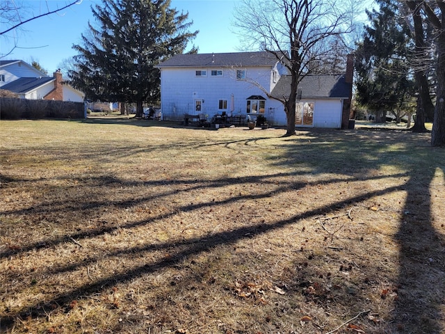 rear view of property with a yard