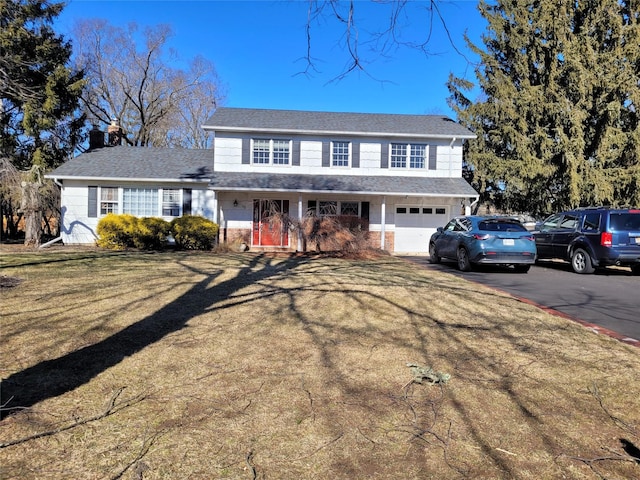 view of front of property with a garage and a front lawn