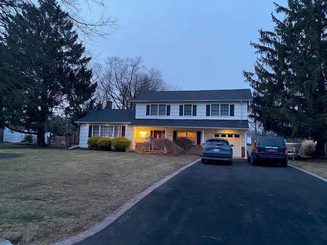 view of front facade with a garage and a front yard