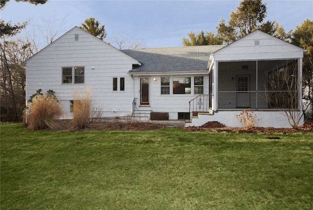 back of house with a yard and a sunroom