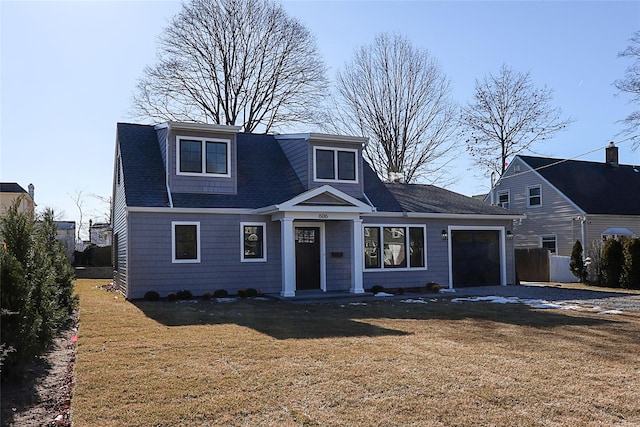 view of front of home with a garage and a front yard