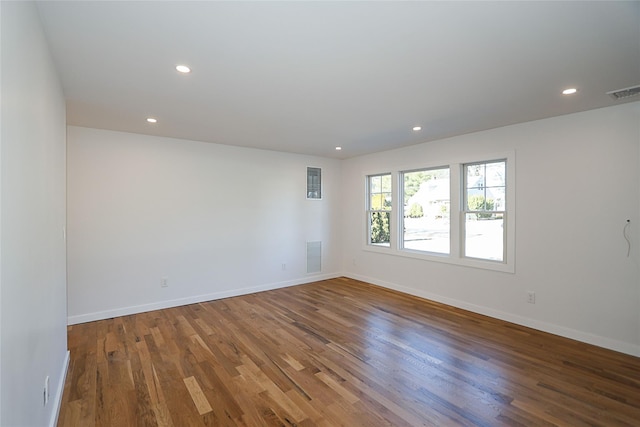 spare room featuring wood-type flooring