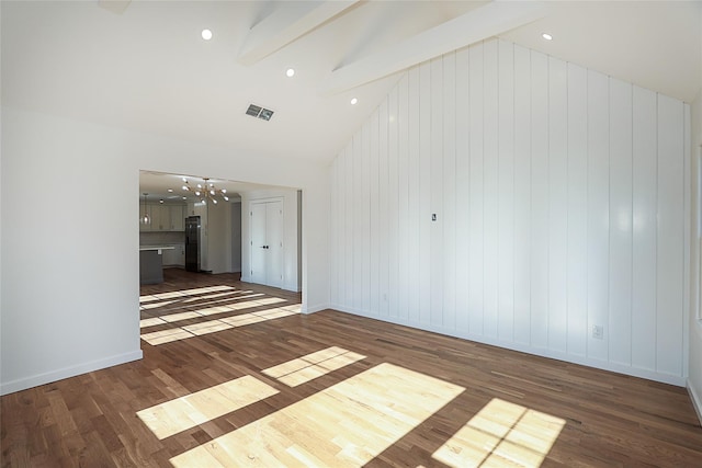 empty room with beam ceiling, dark hardwood / wood-style floors, and high vaulted ceiling