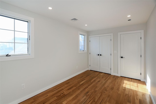 unfurnished bedroom with wood-type flooring