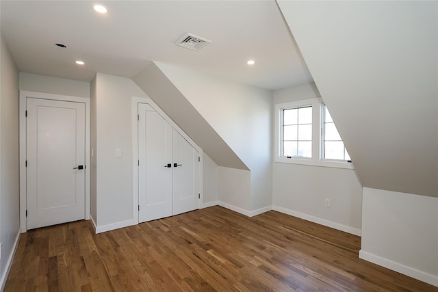 additional living space with dark wood-type flooring