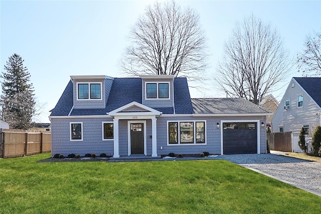 view of front of house with a garage and a front lawn