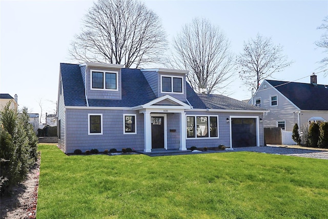 view of front of property with a garage and a front yard