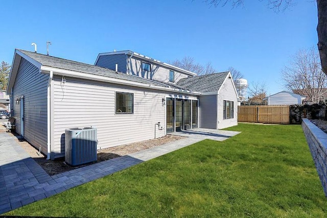 back of house featuring cooling unit, a yard, and a patio area