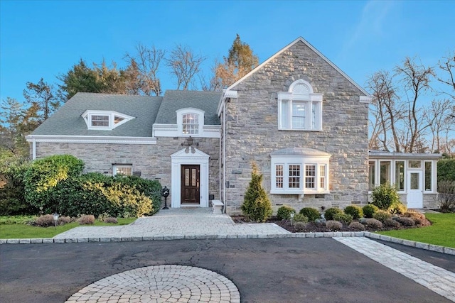 view of front of home featuring a sunroom