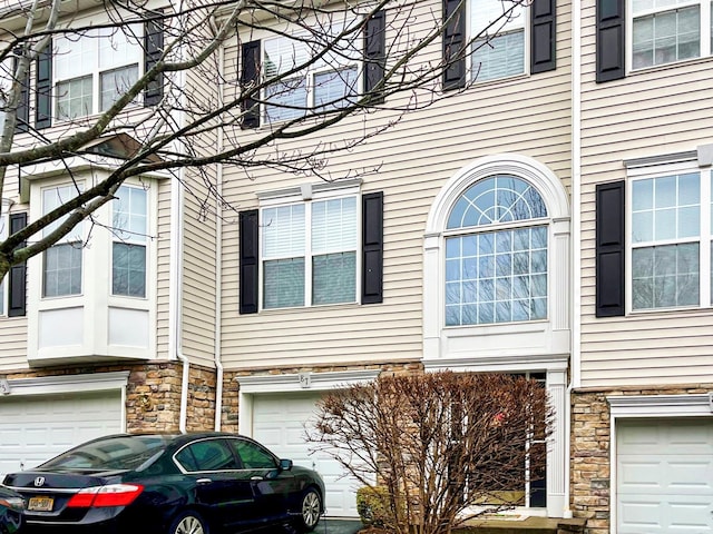 view of home's exterior featuring stone siding and a garage