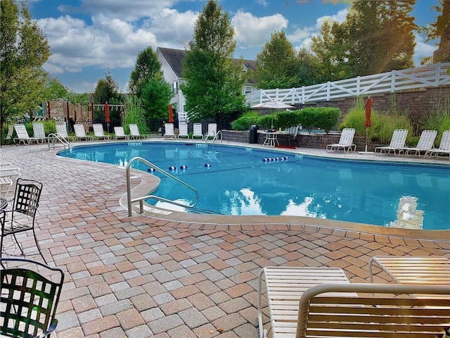 pool featuring a patio area and fence
