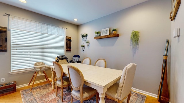 dining room with wood finished floors, baseboards, and recessed lighting