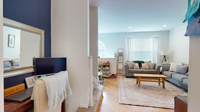 living room with wood-type flooring and recessed lighting
