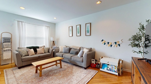 living room featuring light wood finished floors and recessed lighting