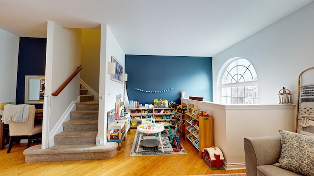 stairs featuring wood finished floors