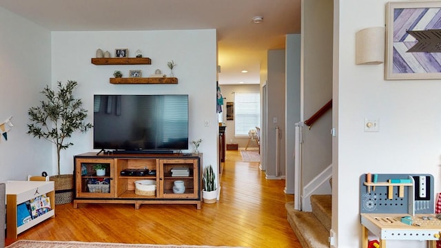 living room with stairs and hardwood / wood-style floors