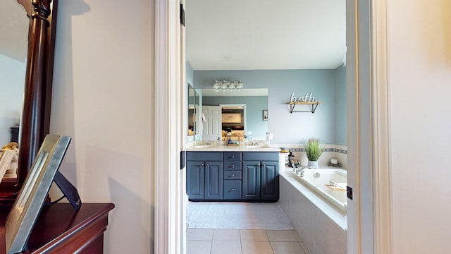 full bath with a bath, double vanity, a sink, and tile patterned floors