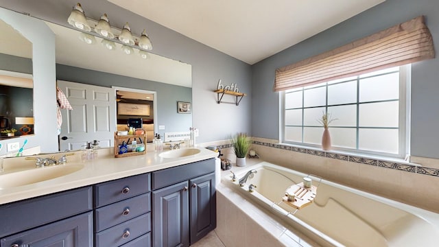 bathroom featuring double vanity, a garden tub, a sink, and ensuite bathroom