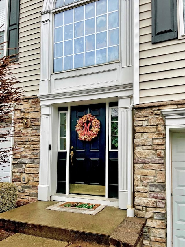 doorway to property with stone siding