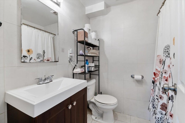 full bathroom featuring toilet, a shower with curtain, tile patterned floors, vanity, and tile walls