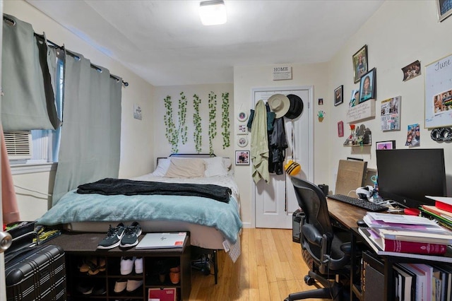 bedroom featuring cooling unit and wood finished floors