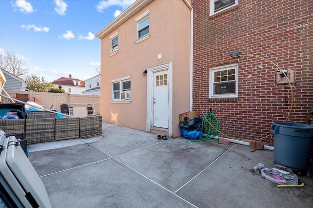 back of house featuring a patio, fence, an outdoor living space, and stucco siding