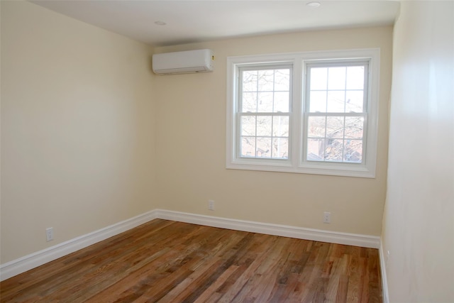 empty room with wood-type flooring and a wall unit AC