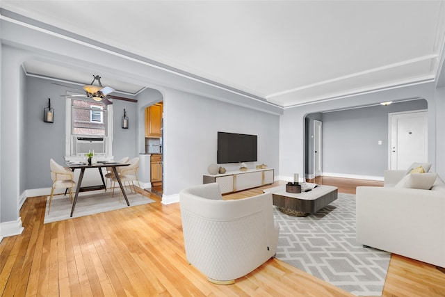 living room with cooling unit, light hardwood / wood-style flooring, and ceiling fan