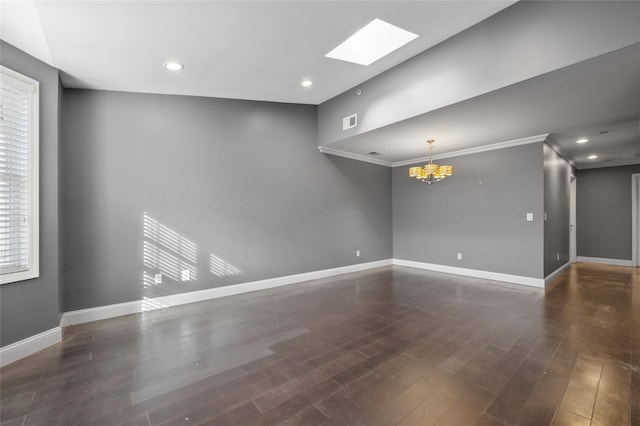 unfurnished room featuring an inviting chandelier, a skylight, ornamental molding, and dark hardwood / wood-style floors