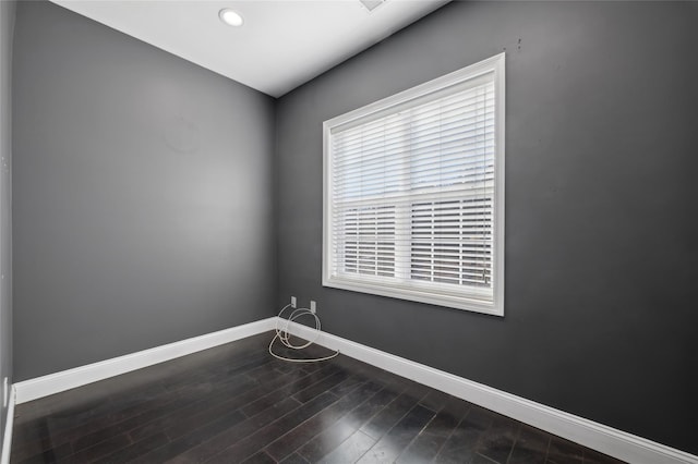 spare room with hardwood / wood-style flooring