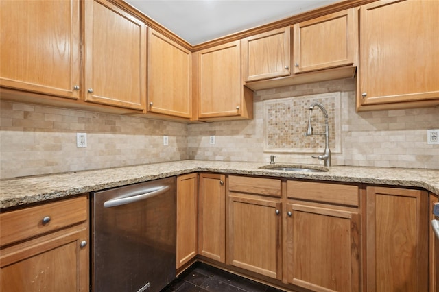 kitchen with tasteful backsplash, dishwasher, sink, dark tile patterned floors, and light stone counters